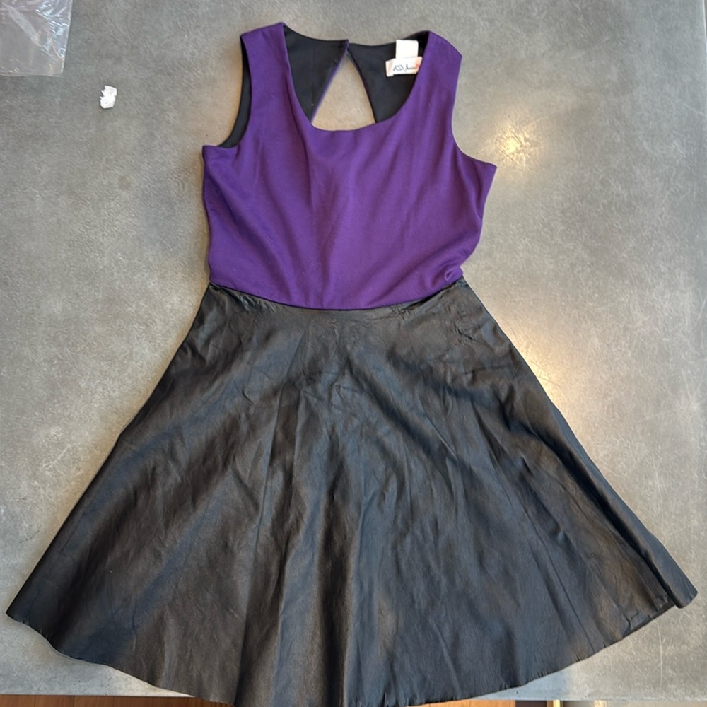 Adorable dress for your daughter. Purple knit top with black leather skirt.